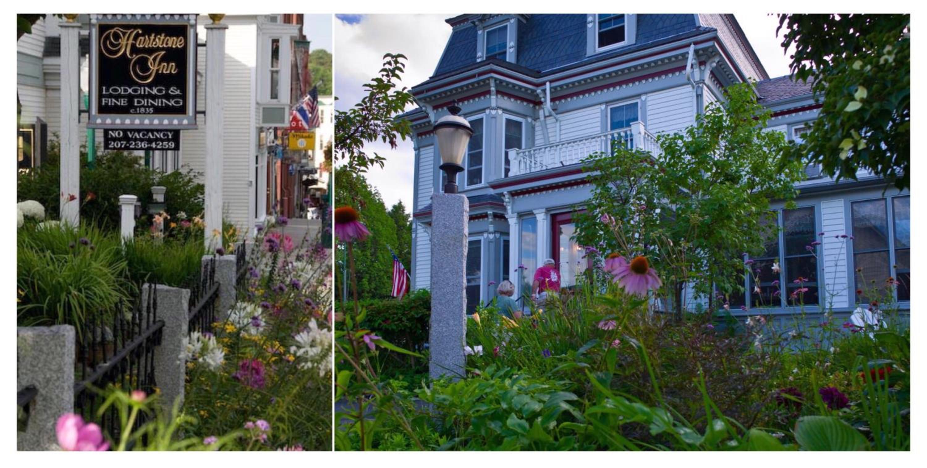Blooming flowers and a street sign border the light blue Victorian facade of Hartstone Inn.