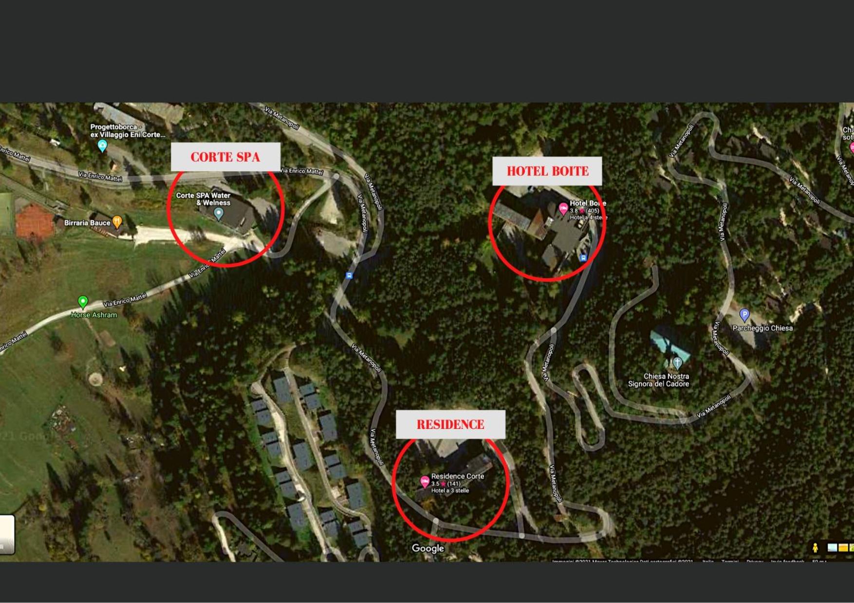 An aerial map marks the layout of buildings and roadways across a forested mountainside.