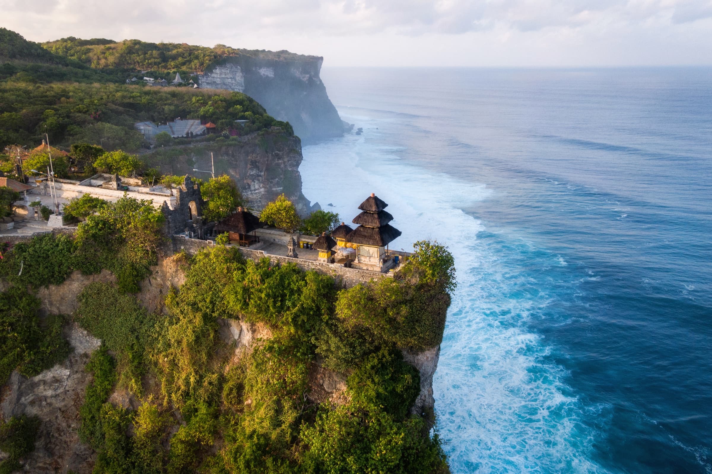 A tropical Balinese setting with palm trees and ocean, a destination wedding backdrop.