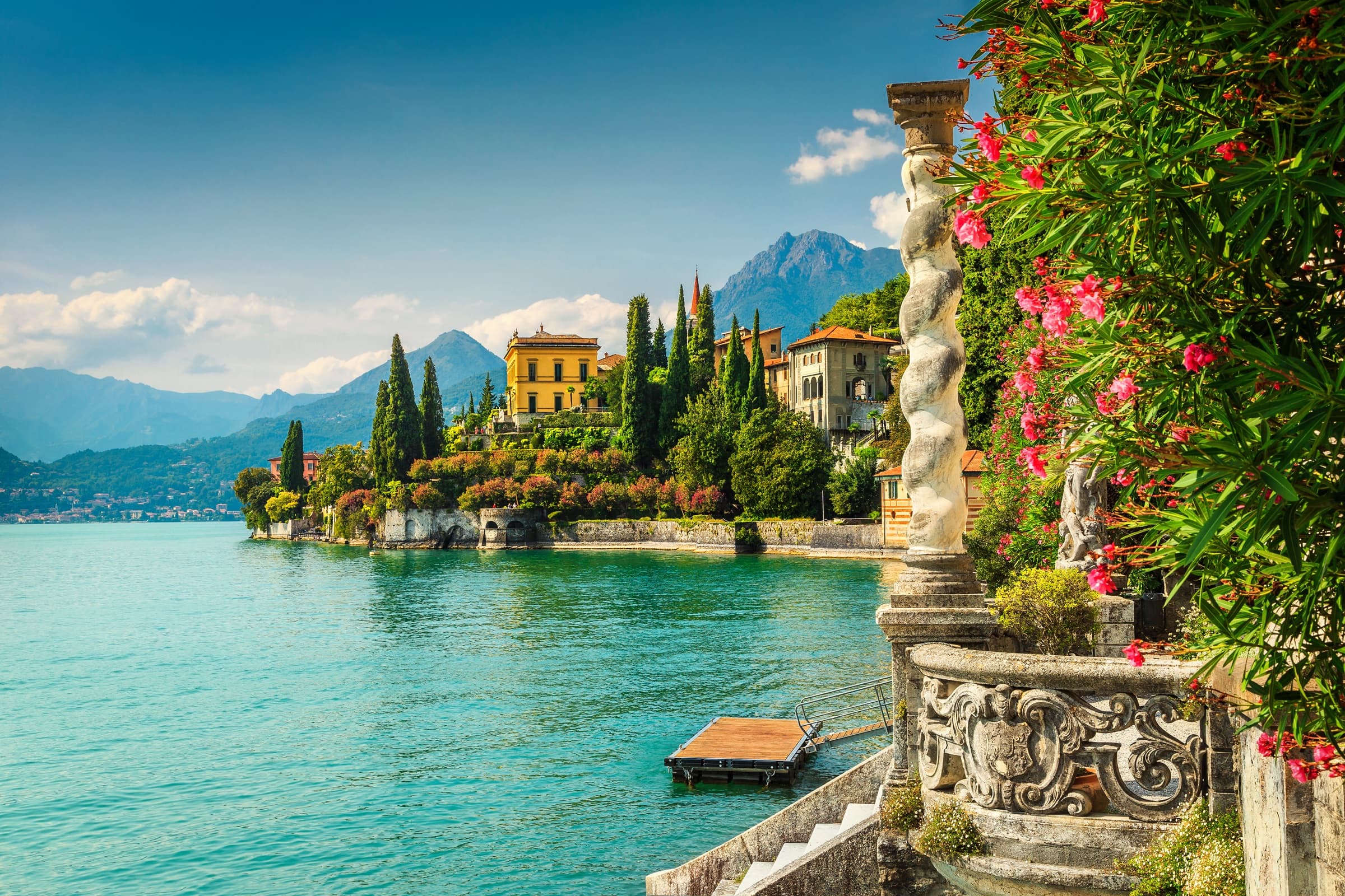 Lake Como, Italy, alpine lake surrounded by historic villas and forested mountains.