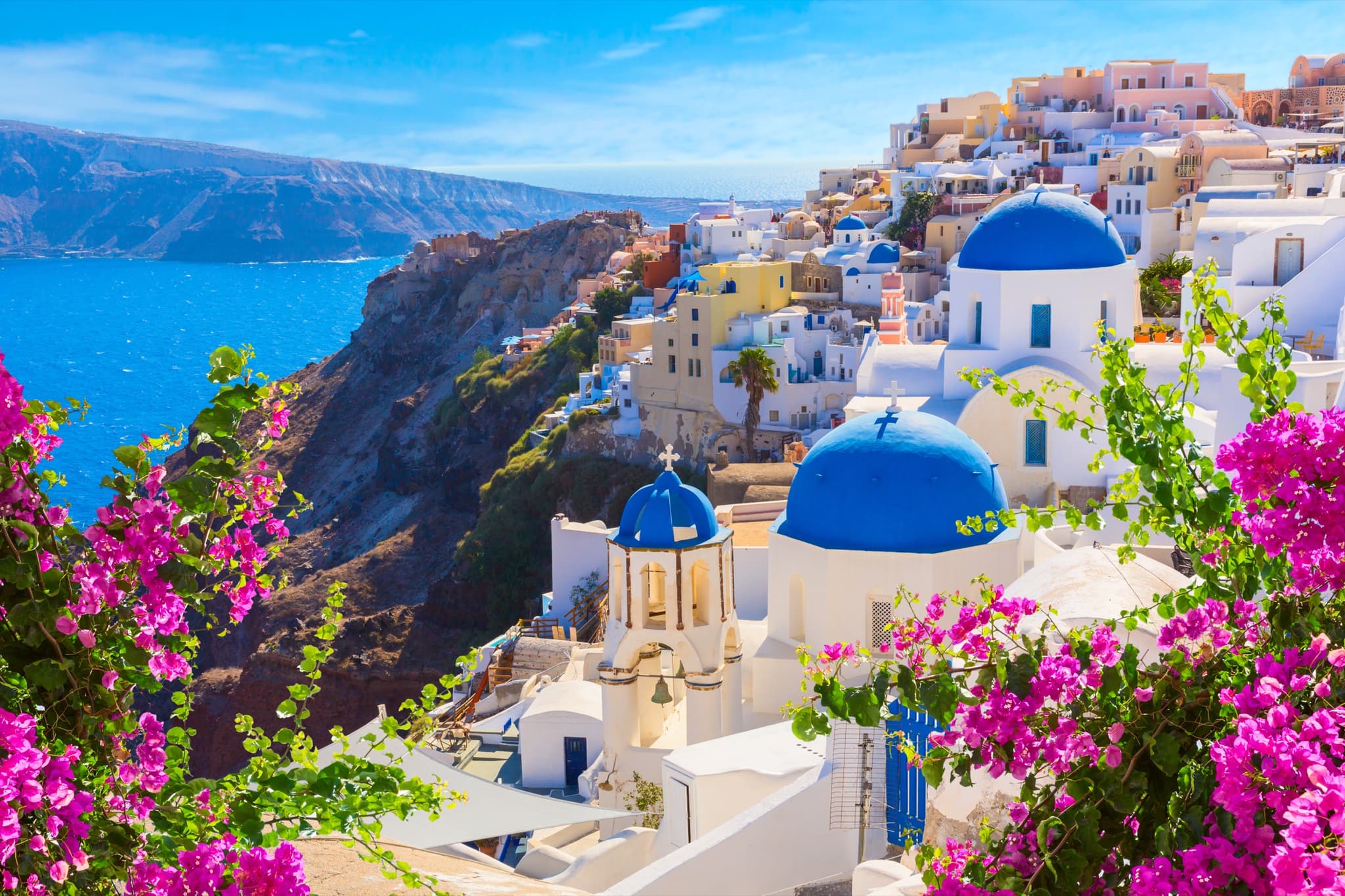 Santorini, Greece, caldera-edge cliffside and white-and-blue Cycladic architecture.