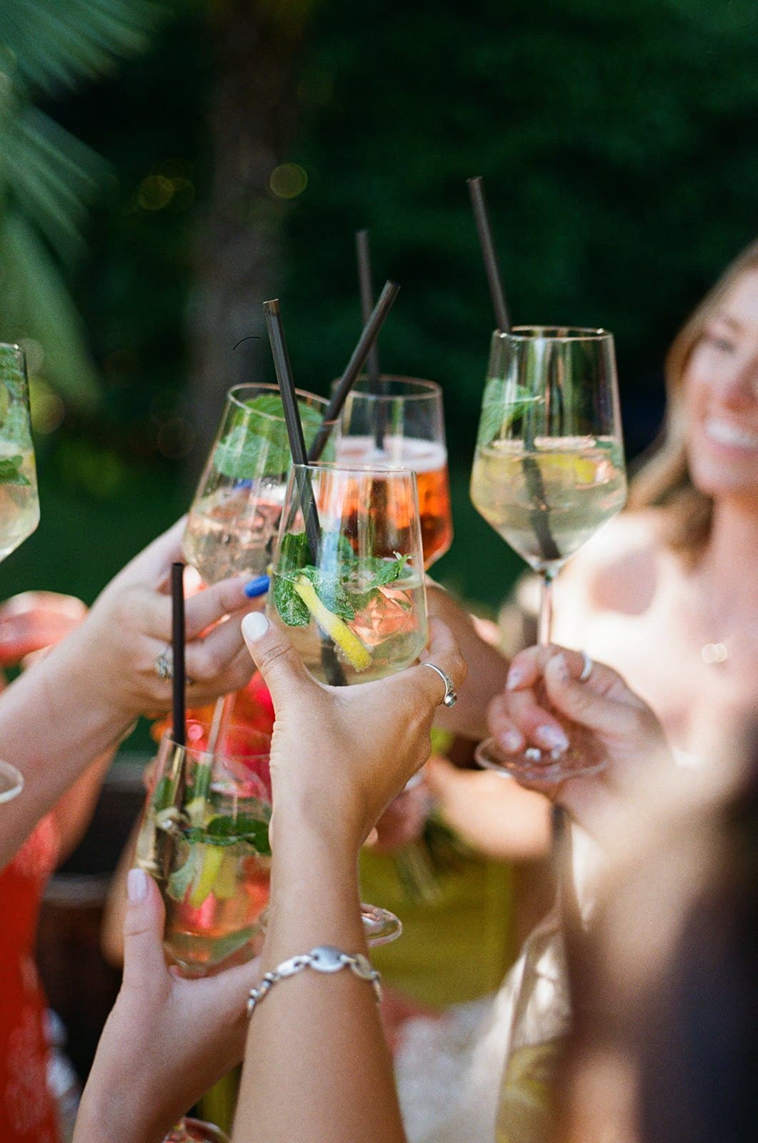 Guests raising spritz glasses in a toast