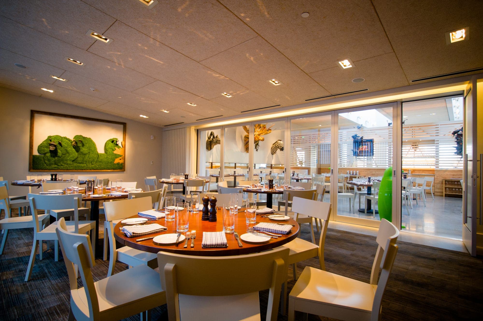 A dining room with round tables set for a reception.