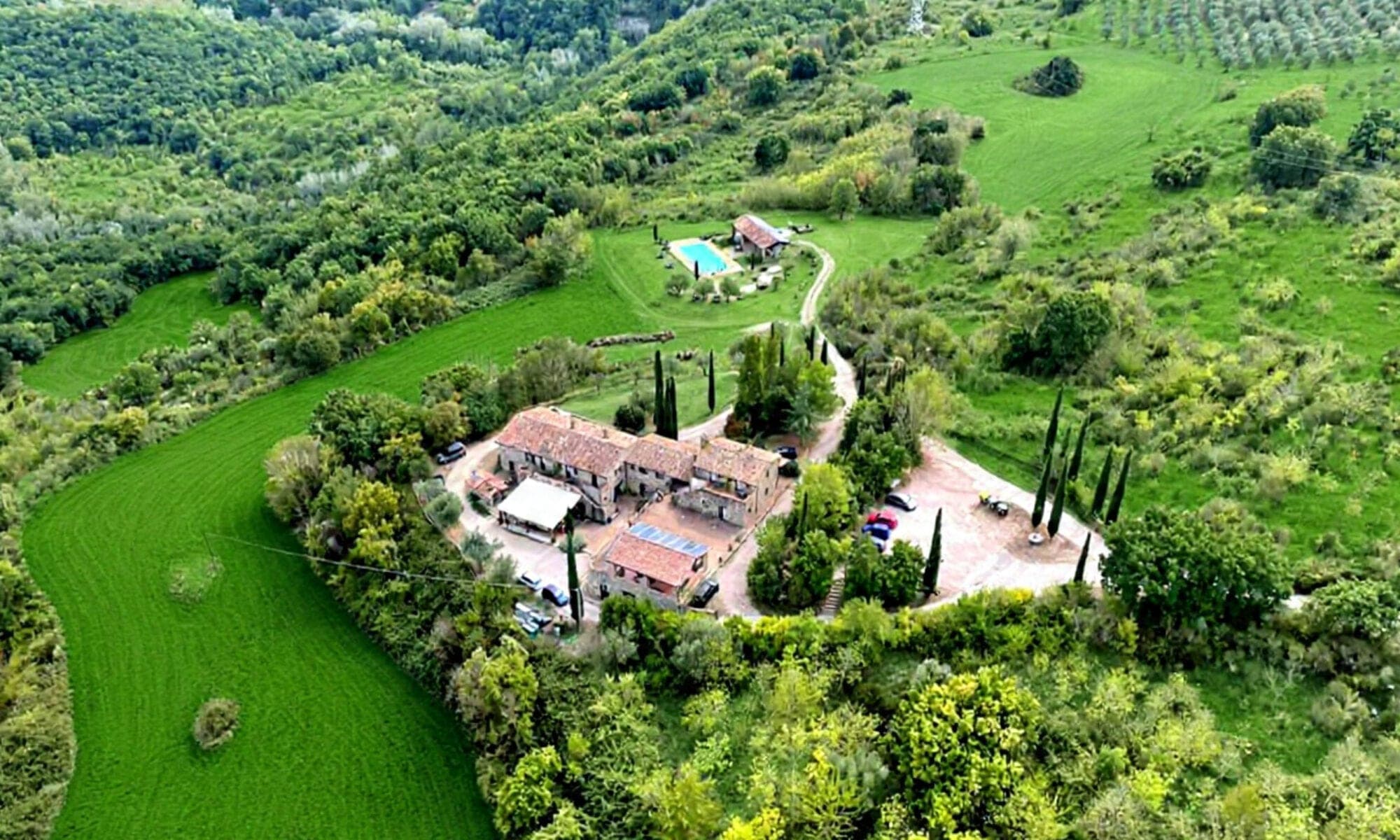 Aerial view of Agriturismo Santa Maria with buildings and a pool