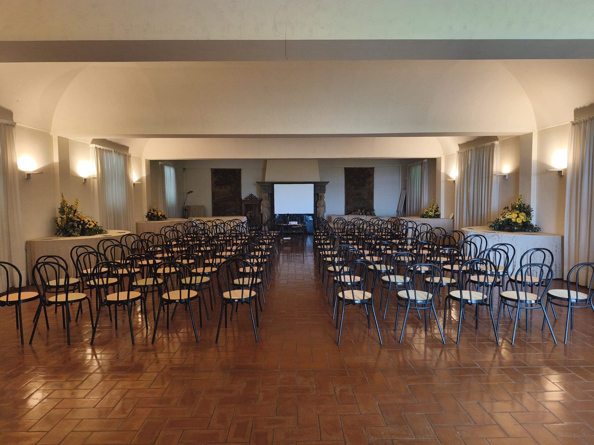 Rows of chairs set up for a ceremony in a well-lit room.