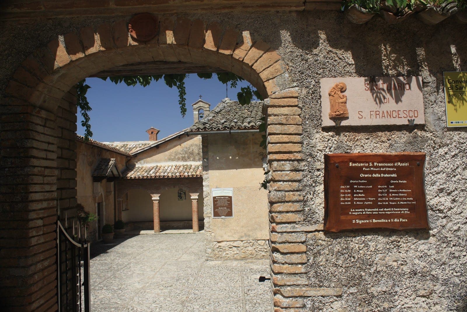 Courtyard with an archway and signs on the wall