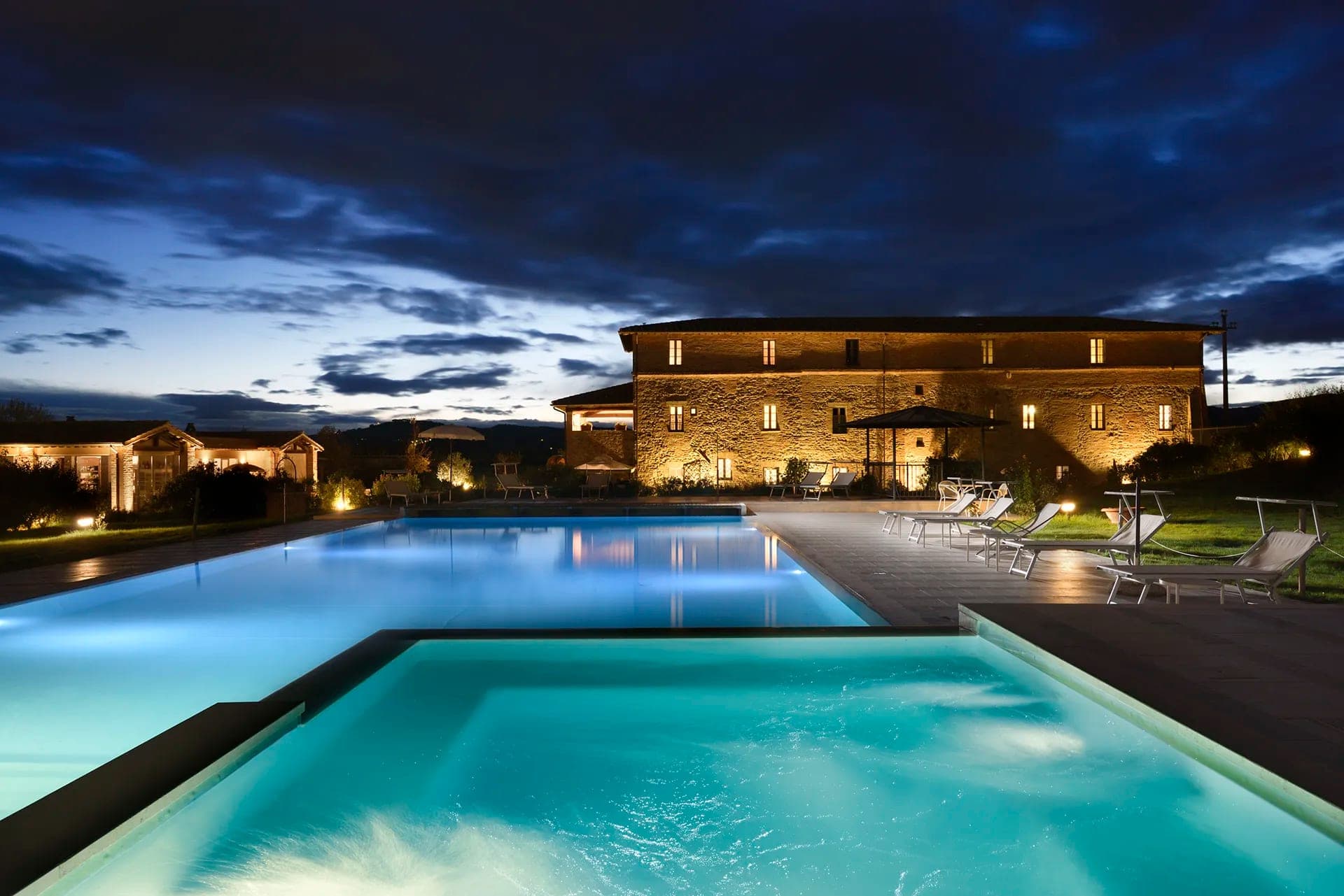 Anna Boccali Resort swimming pool and buildings at dusk