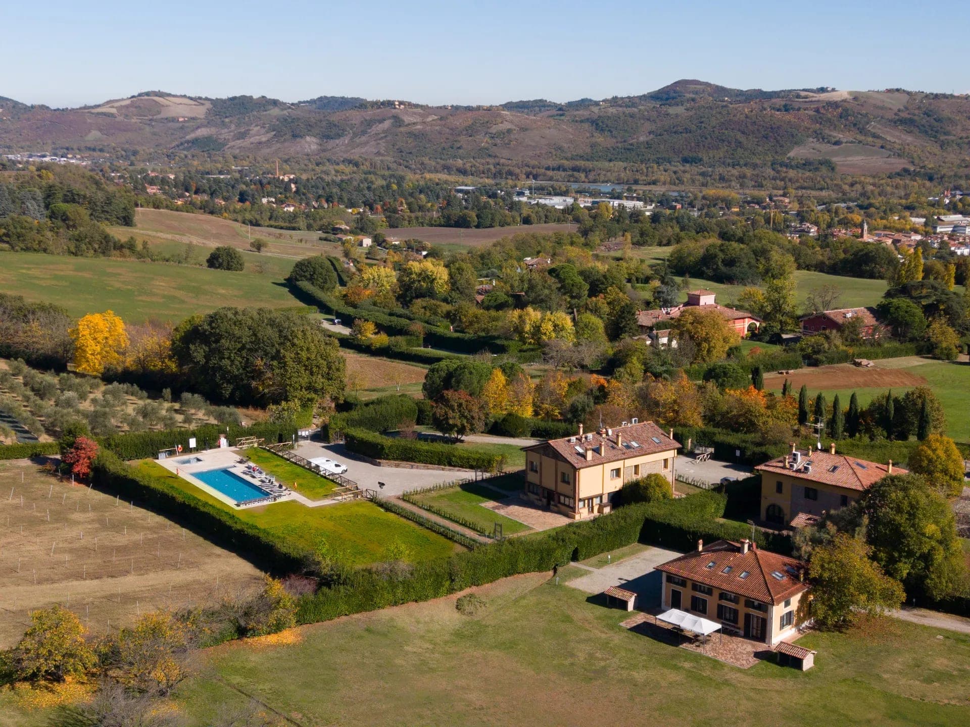 Aerial view of Borgo Malvasia- La Quercia with buildings and a swimming pool.