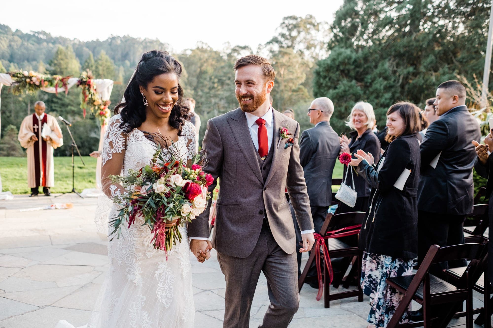 Bride and groom walk down aisle at outdoor wedding ceremony