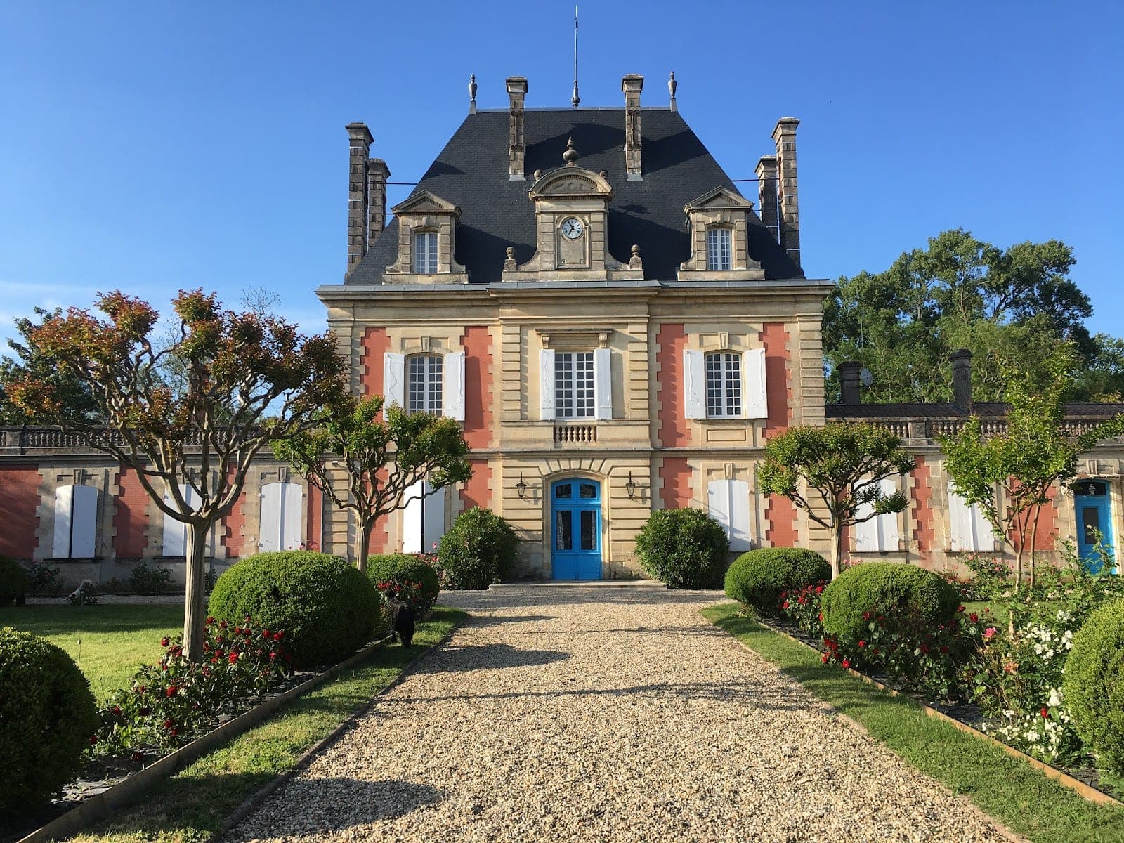 Chateau Saint Ahon exterior with a gravel driveway and manicured gardens.