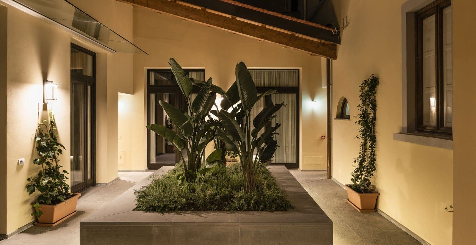 Courtyard with plants and lighting at night
