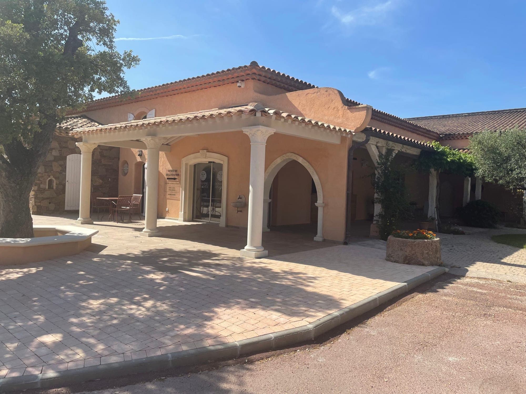 Exterior of a building with a covered entrance and columns.