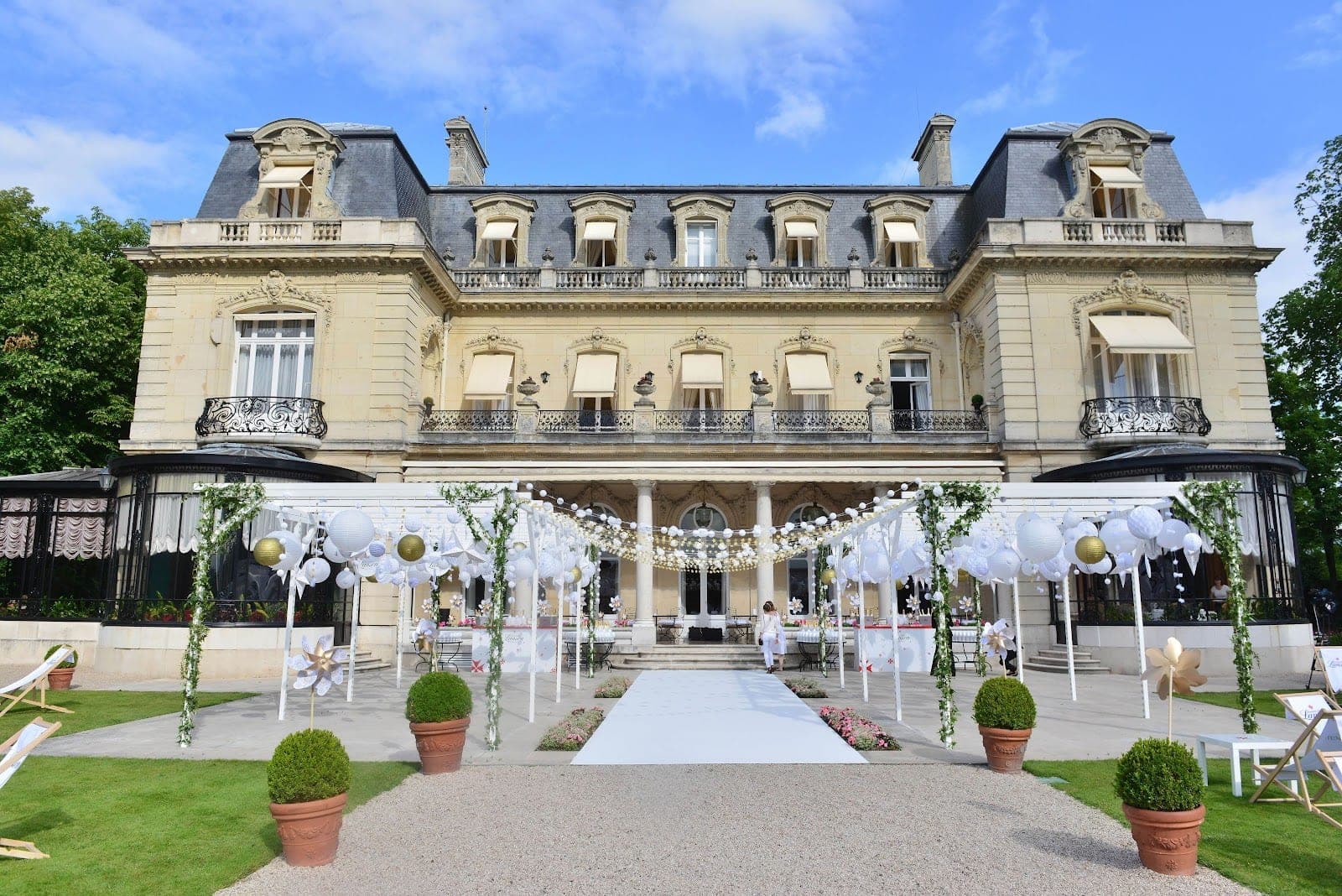 Exterior of a grand building with a wedding aisle and decorations