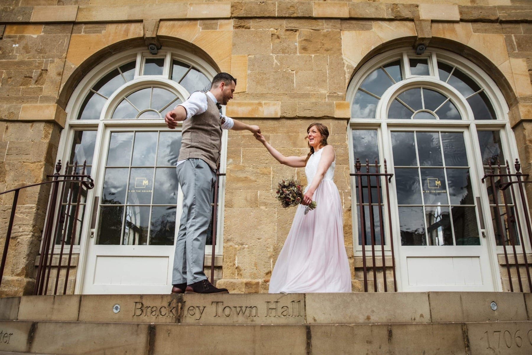 A bride and groom dance on the steps of Brackley Town Hall.