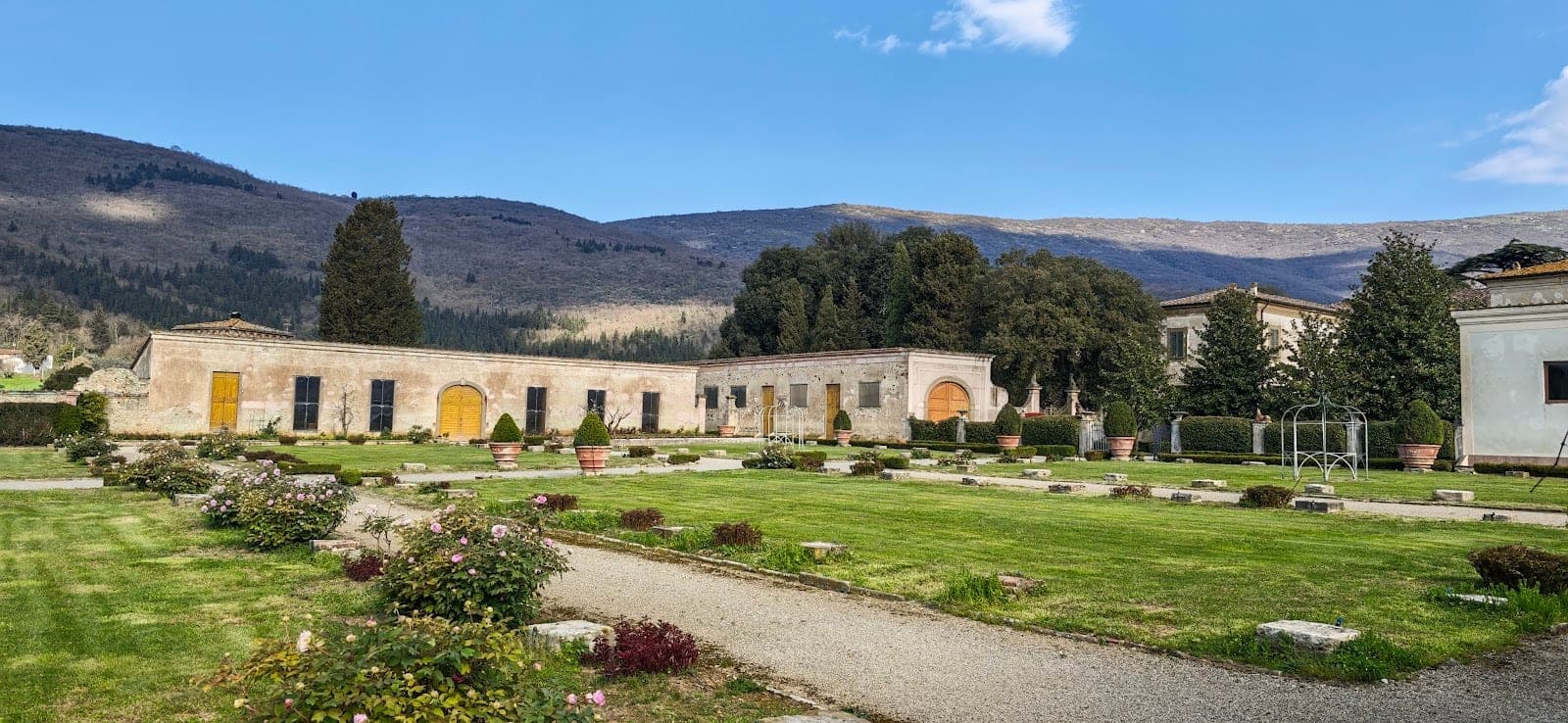 Exterior buildings and manicured gardens at Fattoria di Travalle.