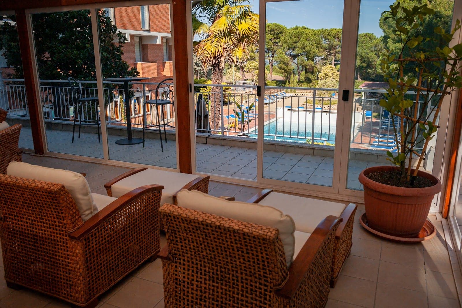 Terrace with swimming pool and seating area at a resort.