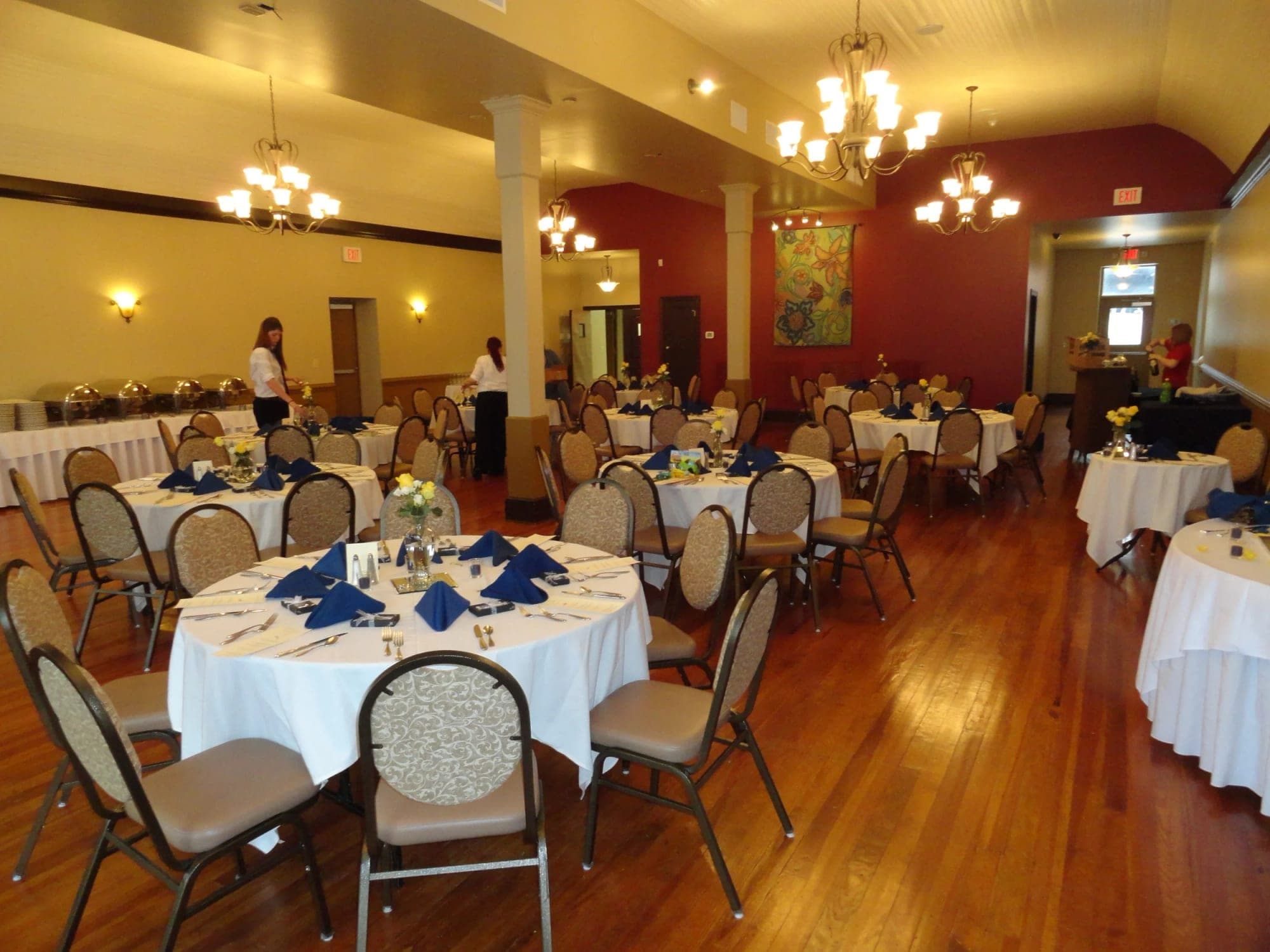 A reception hall with round tables set for dining.