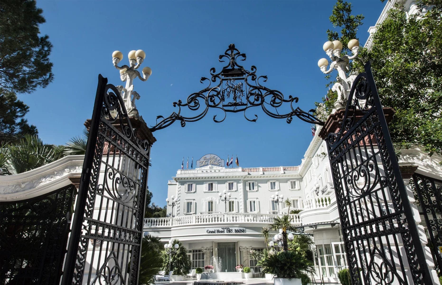 Grand Hotel Des Bains entrance with ornate gates and white facade