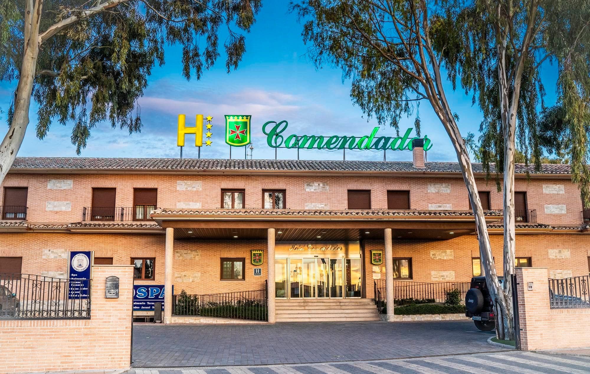 Exterior of Hotel Comendador with signage and entrance.