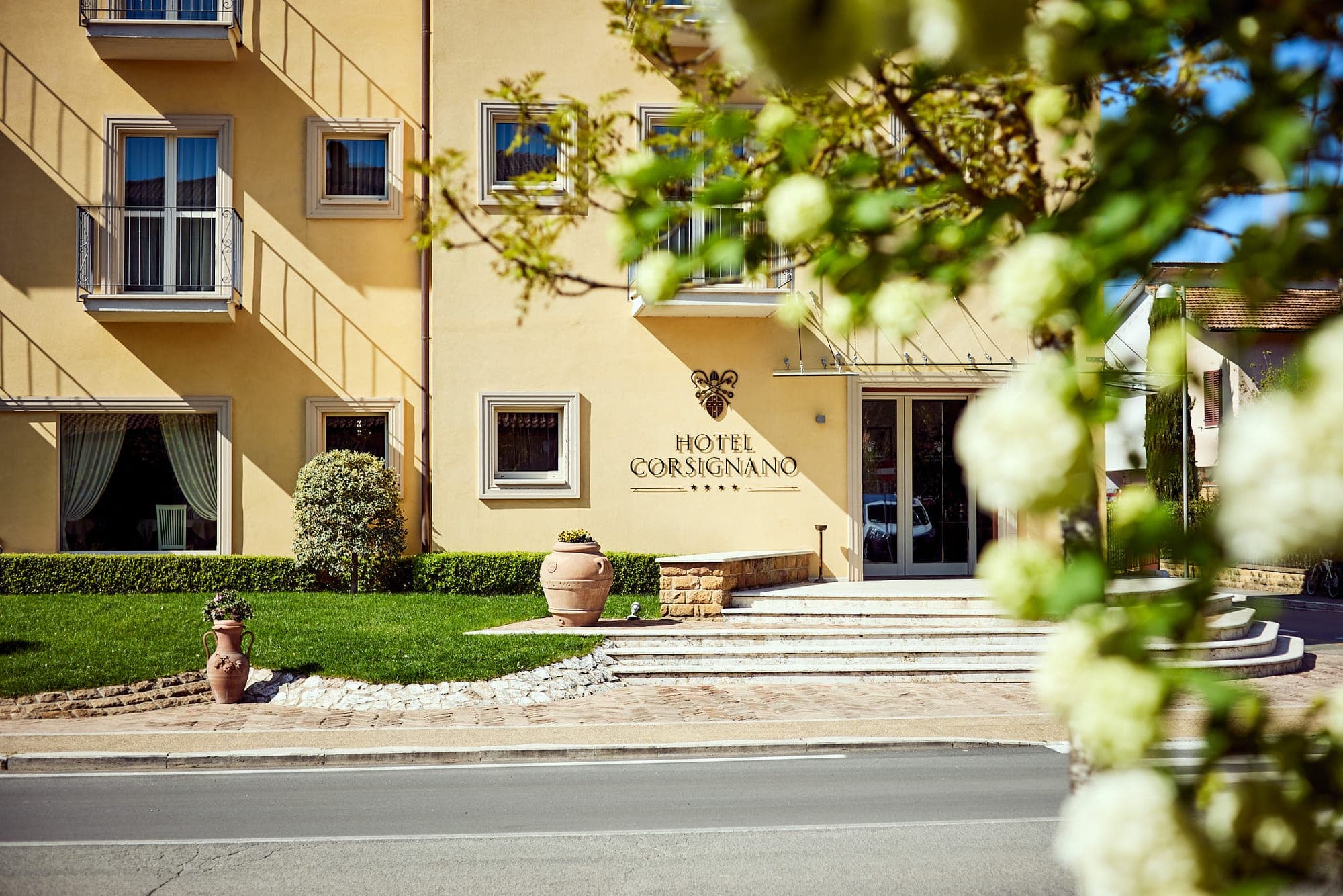 Hotel Corsignano entrance with steps and signage.