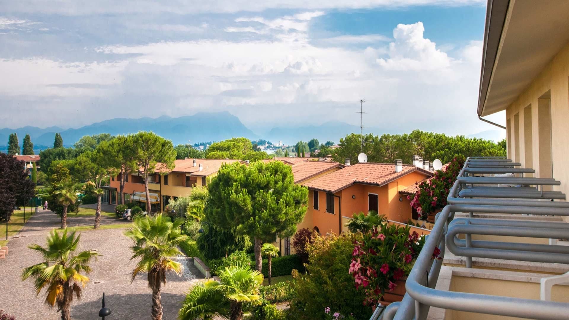 View of hotel buildings and grounds with mountains in the distance.
