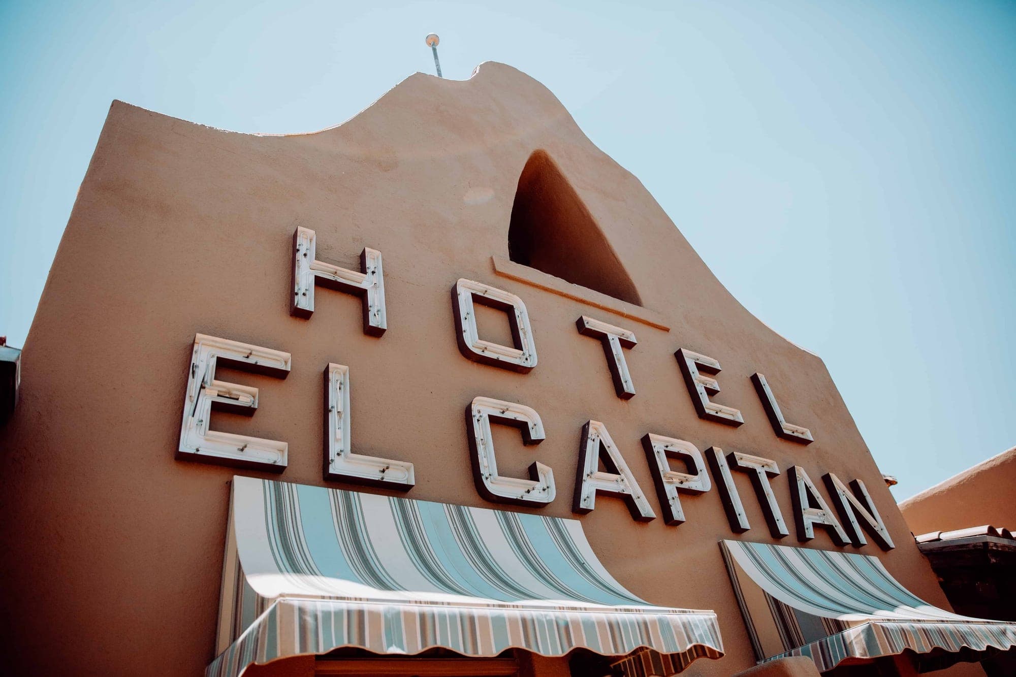 The exterior of Hotel El Capitan with its name in large letters.
