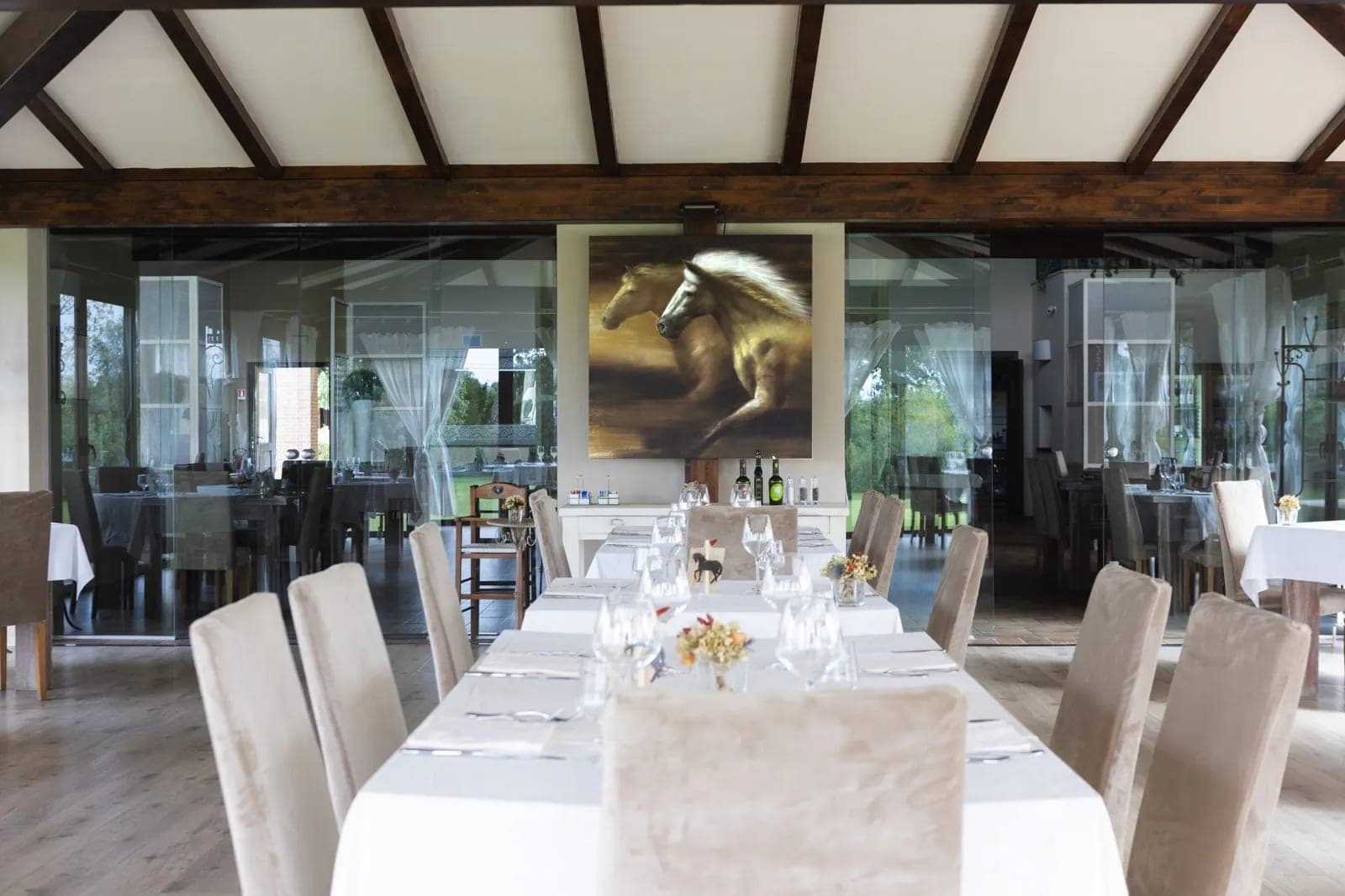 A dining room with tables set for a wedding reception.