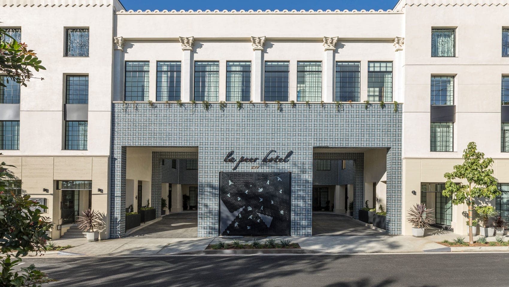 Exterior of the La Peer Hotel with a covered entrance and tiled facade.