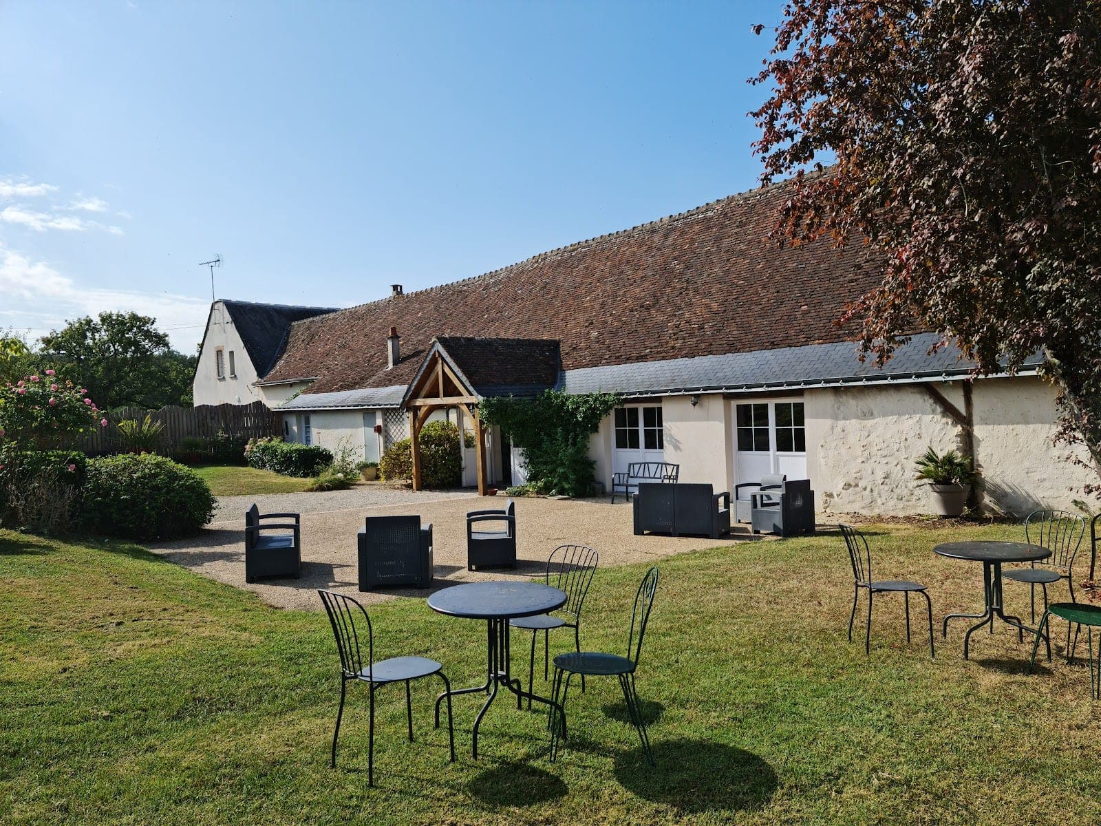 Exterior of a wedding venue with outdoor seating and a large tiled roof.