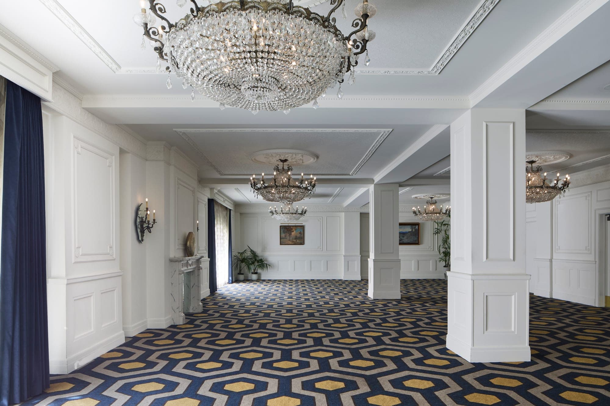 Ballroom with chandeliers and patterned carpet