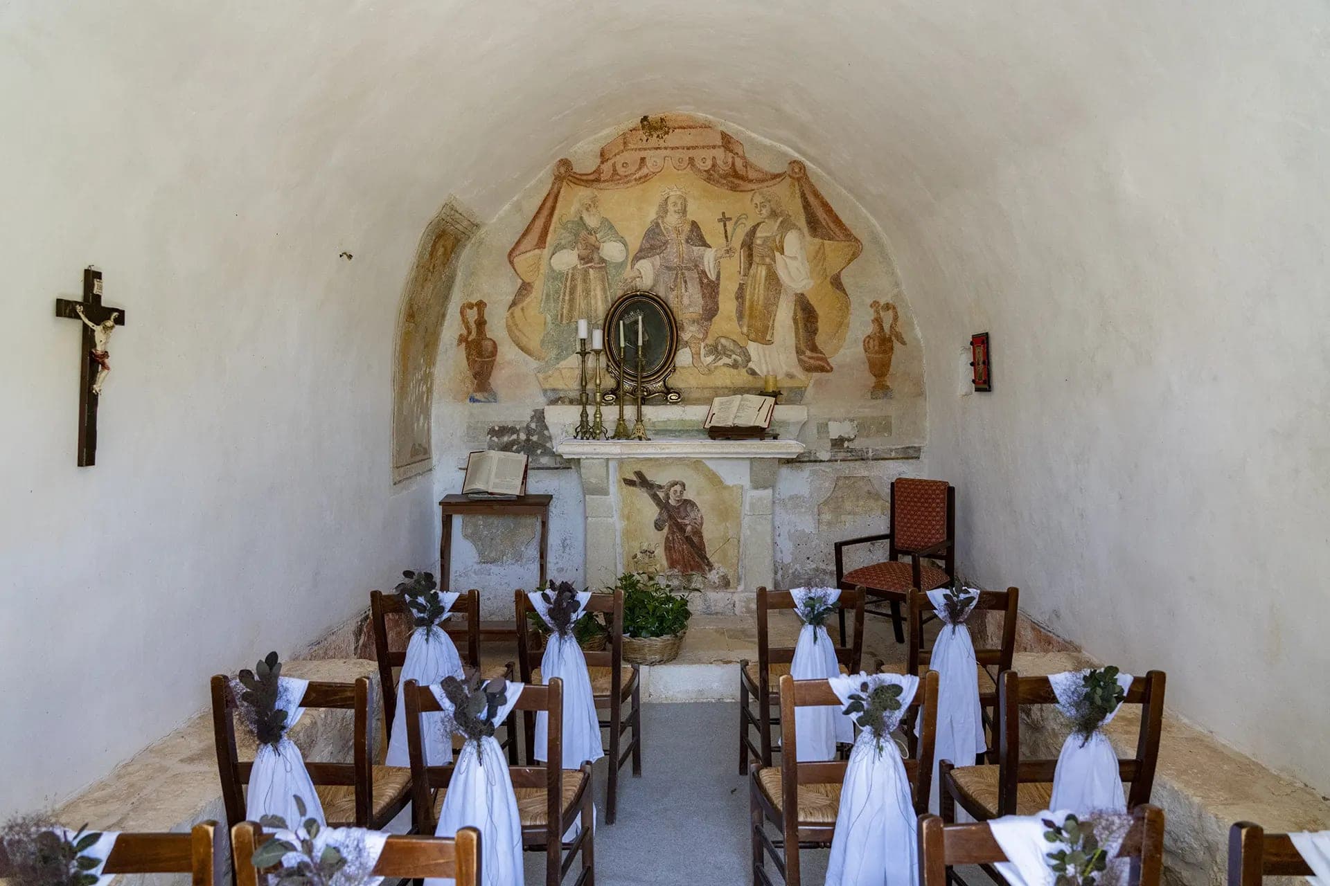 Chapel interior with chairs decorated for a wedding ceremony.