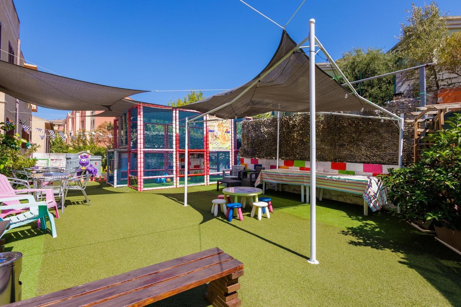 Outdoor play area with soft play structure and seating