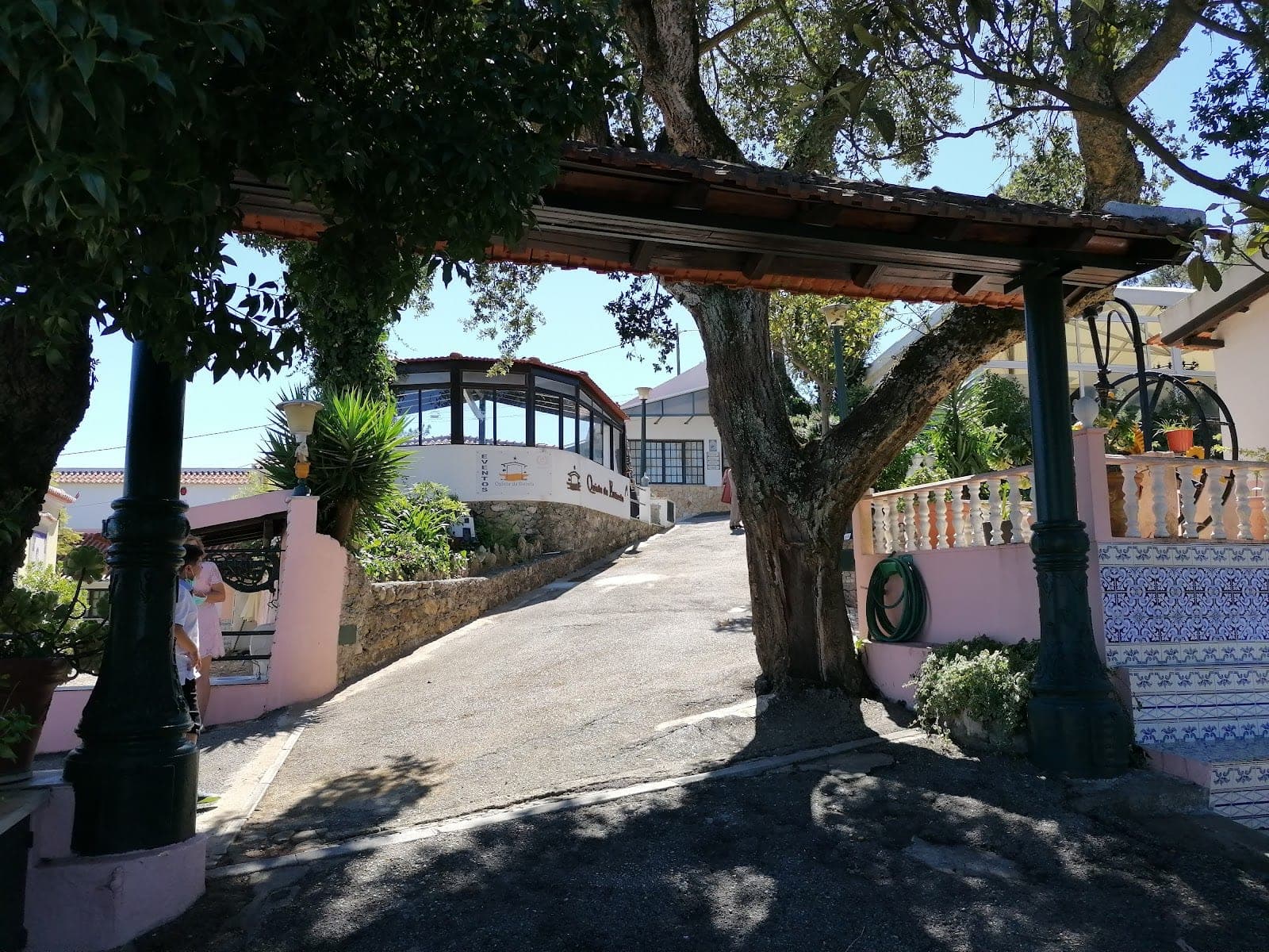 Entrance to Quinta da Estrela with a covered walkway and trees.