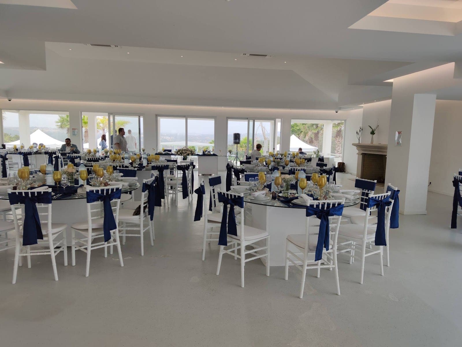 Reception room with round tables set for a wedding