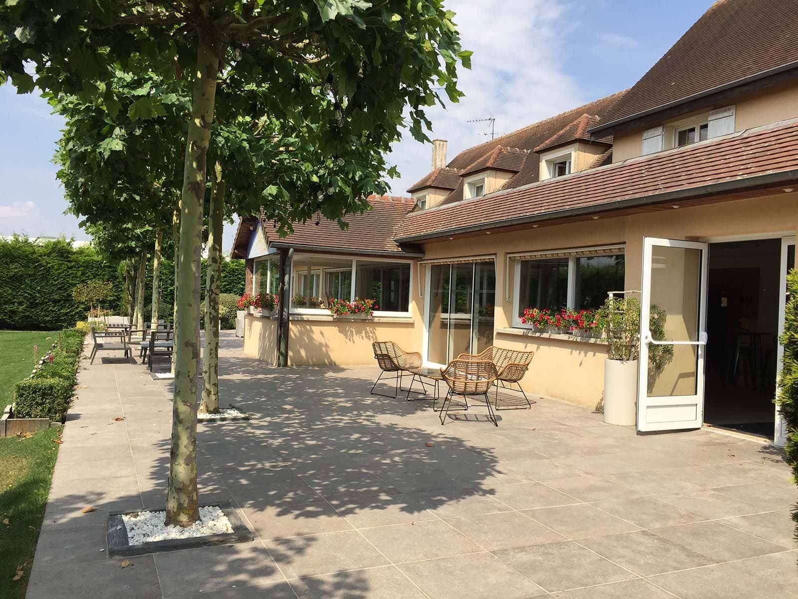 Terrace with outdoor seating and building exterior at a wedding venue.