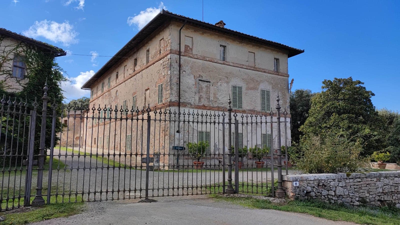 Exterior of a historic building with a large wrought iron gate.