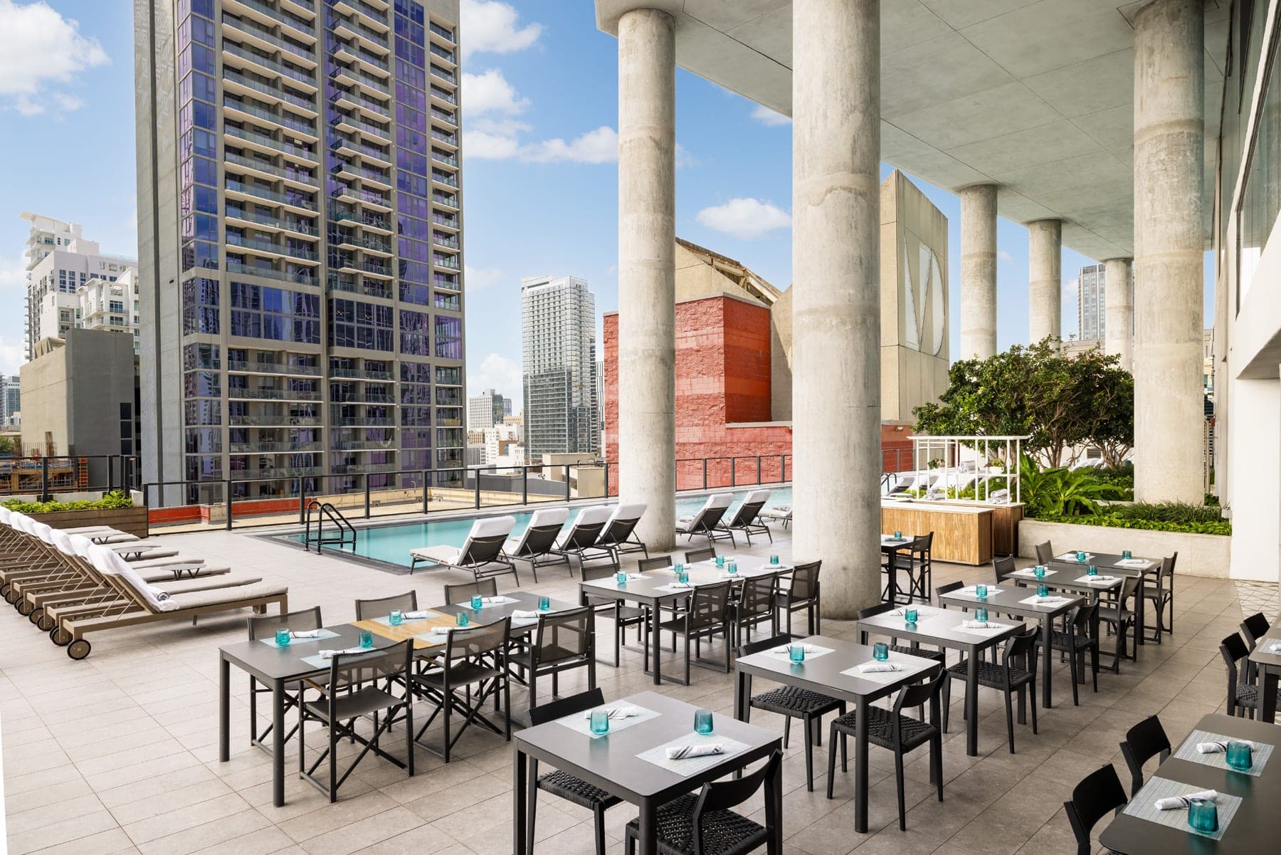 Rooftop terrace with pool and dining tables at The Elser Hotel Miami.