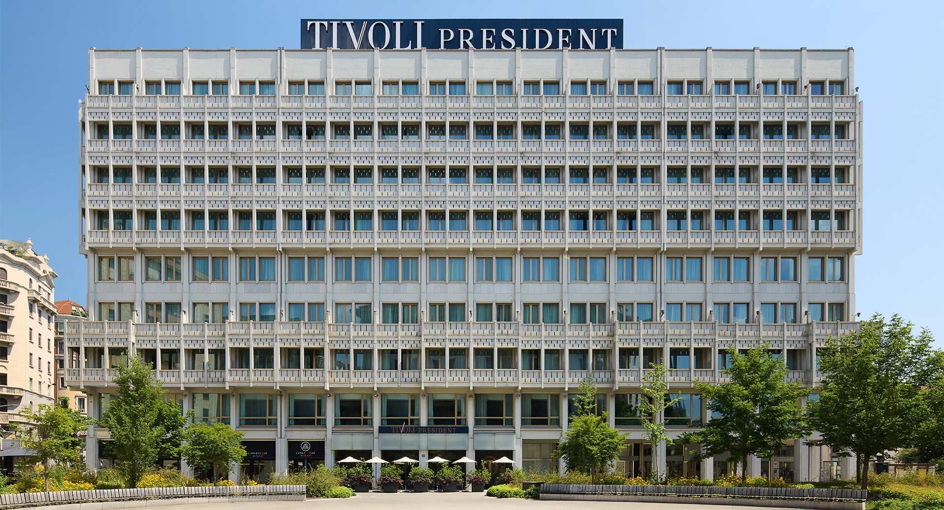 Exterior of the Tivoli President hotel building with a blue sky.