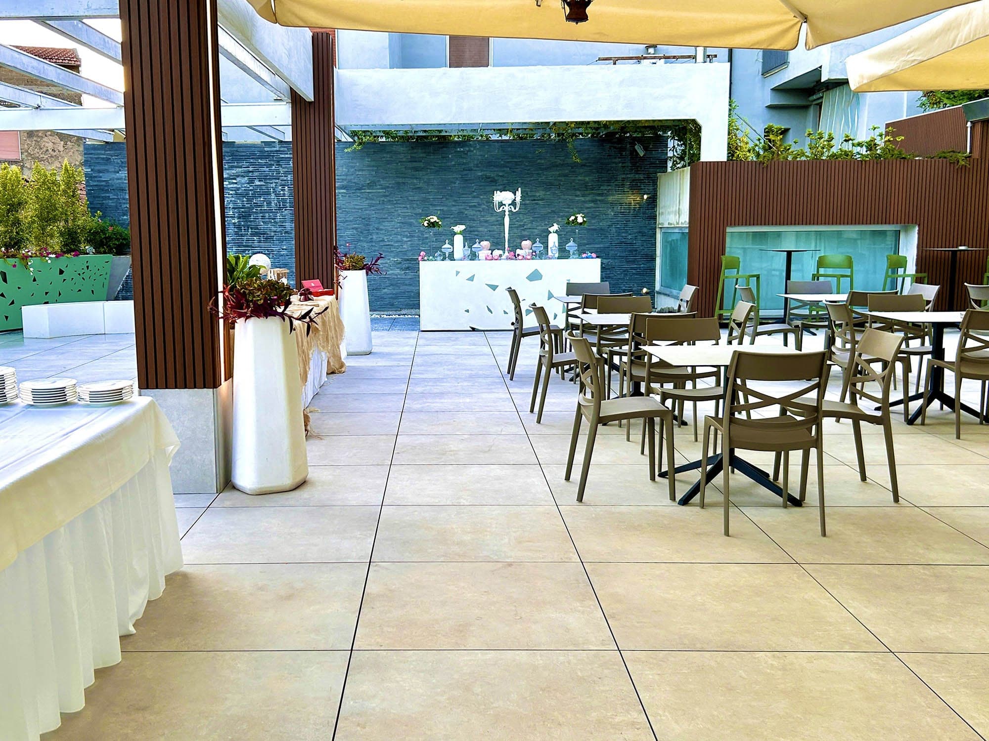 Outdoor dining area with tables and chairs set up under a canopy.
