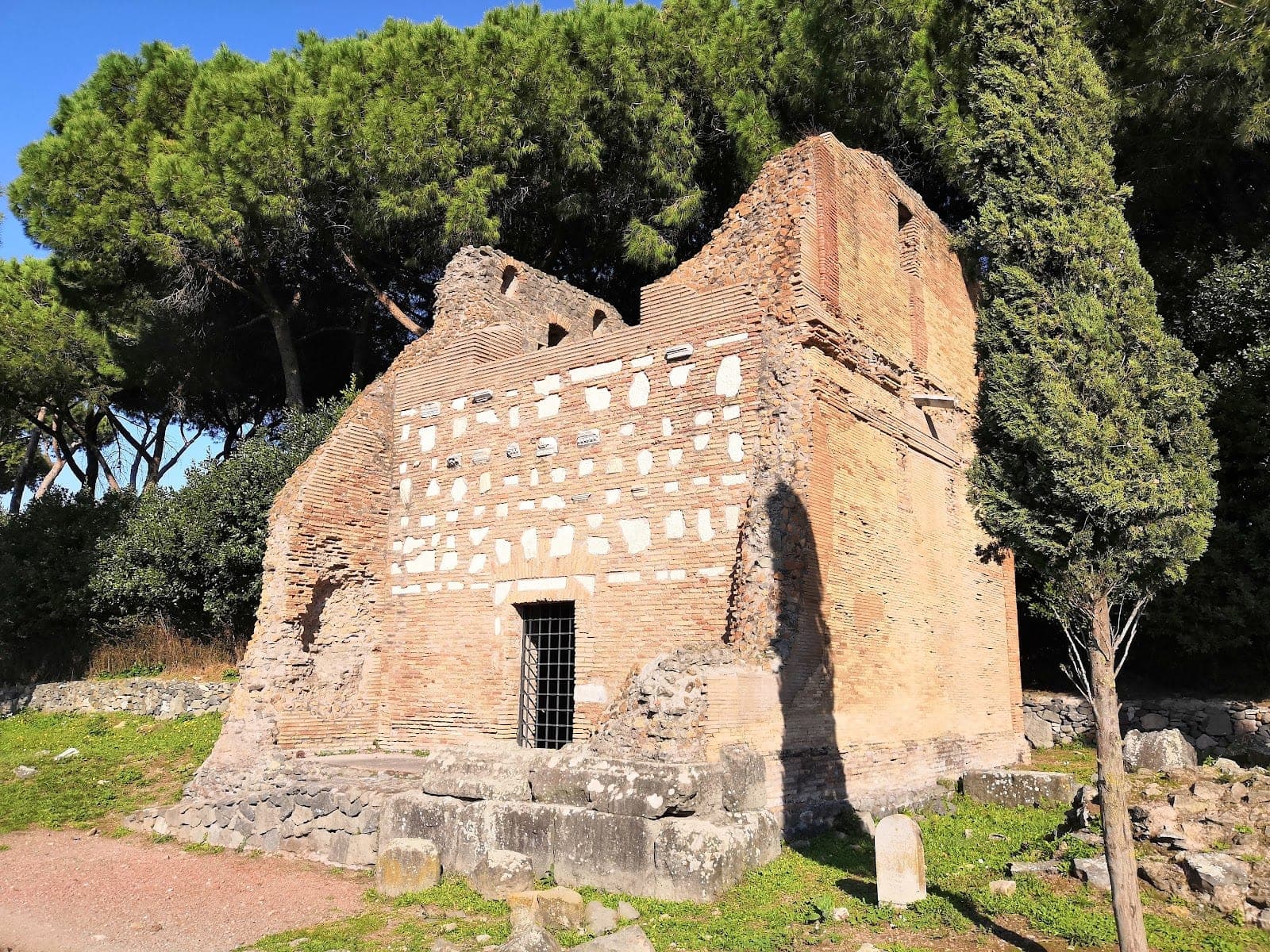 Ancient brick ruin with trees and a clear blue sky