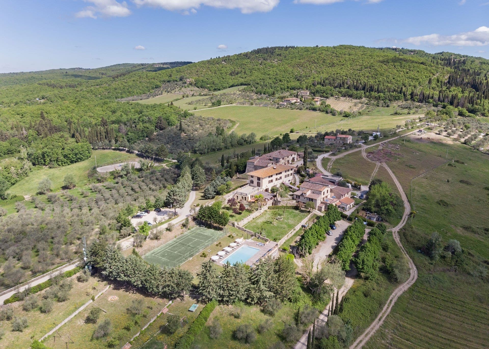 Aerial view of Villa Casafrassi with surrounding Tuscan landscape.