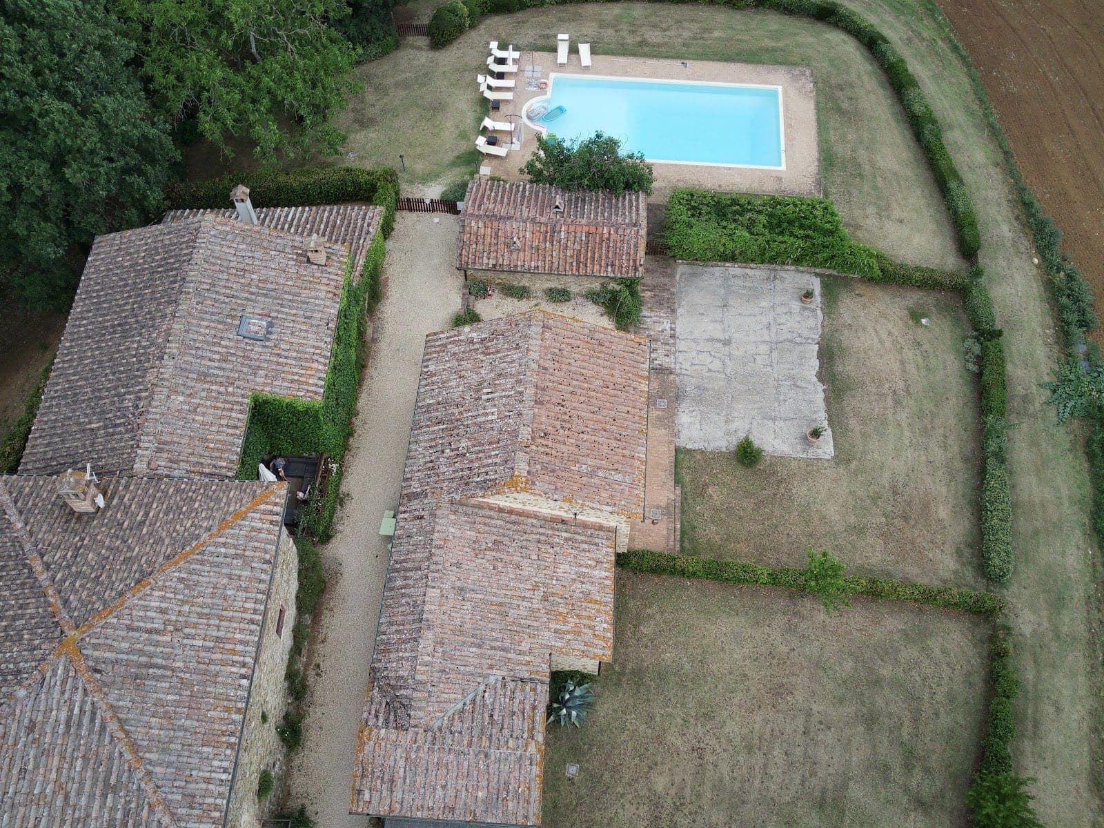 Aerial view of Villa Castellare with a swimming pool and buildings.