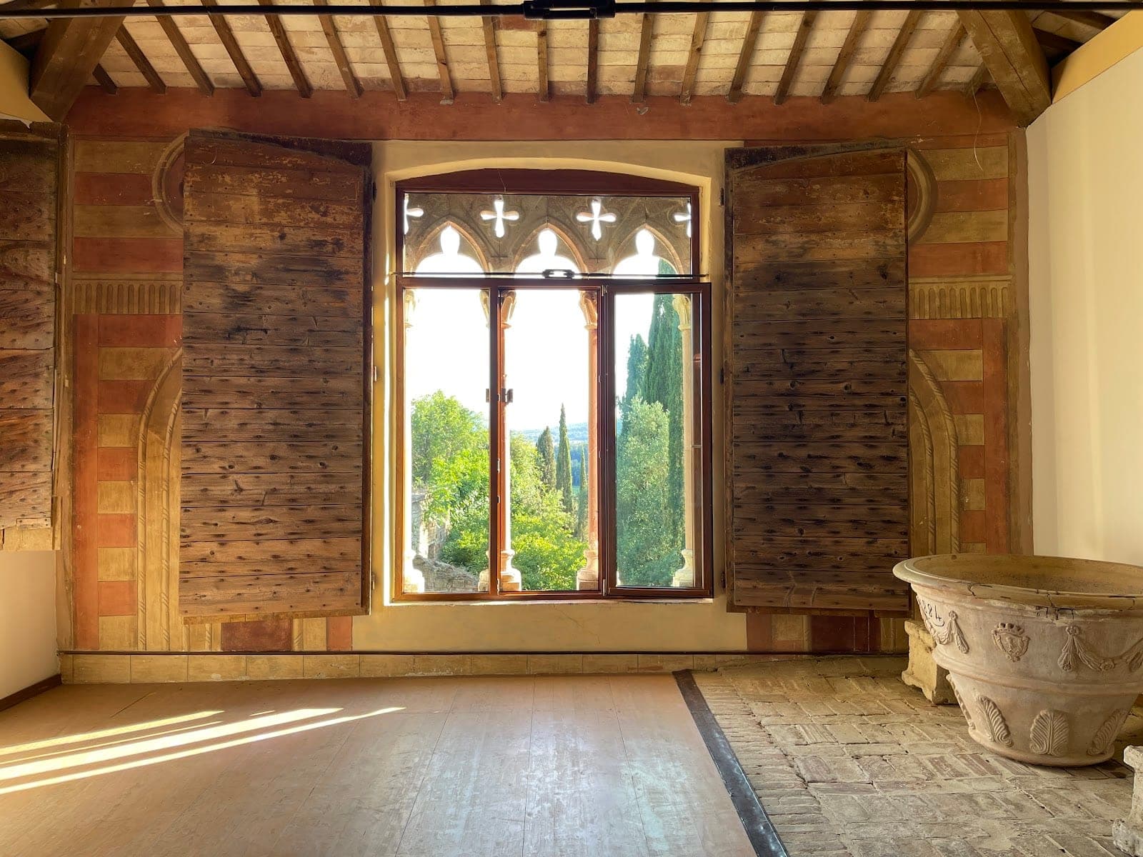 Interior room with large window showing trees and landscape