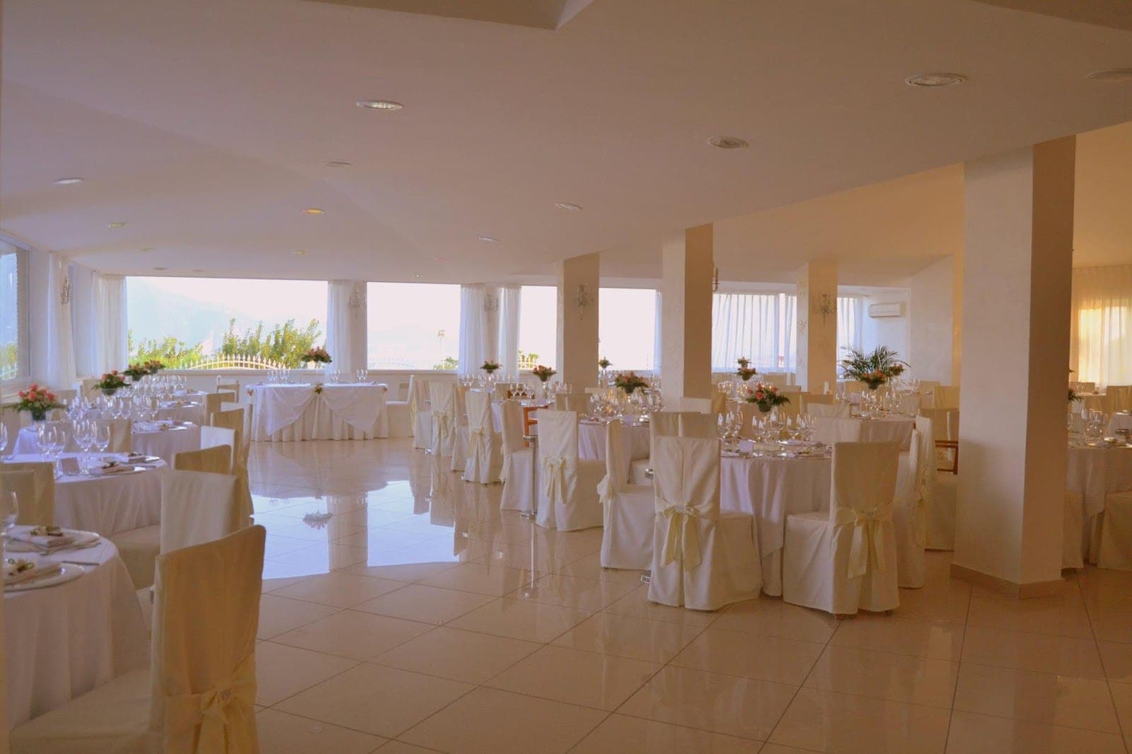 Reception room with tables set for a wedding