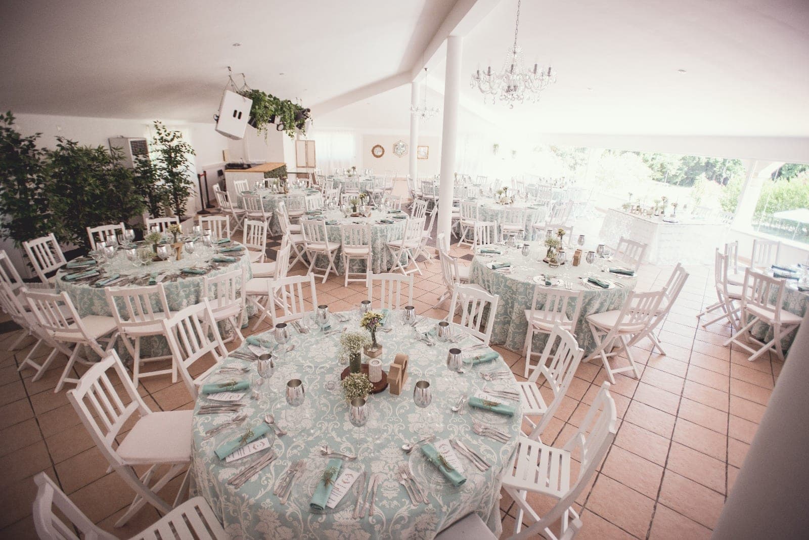 Reception room with round tables set for a wedding