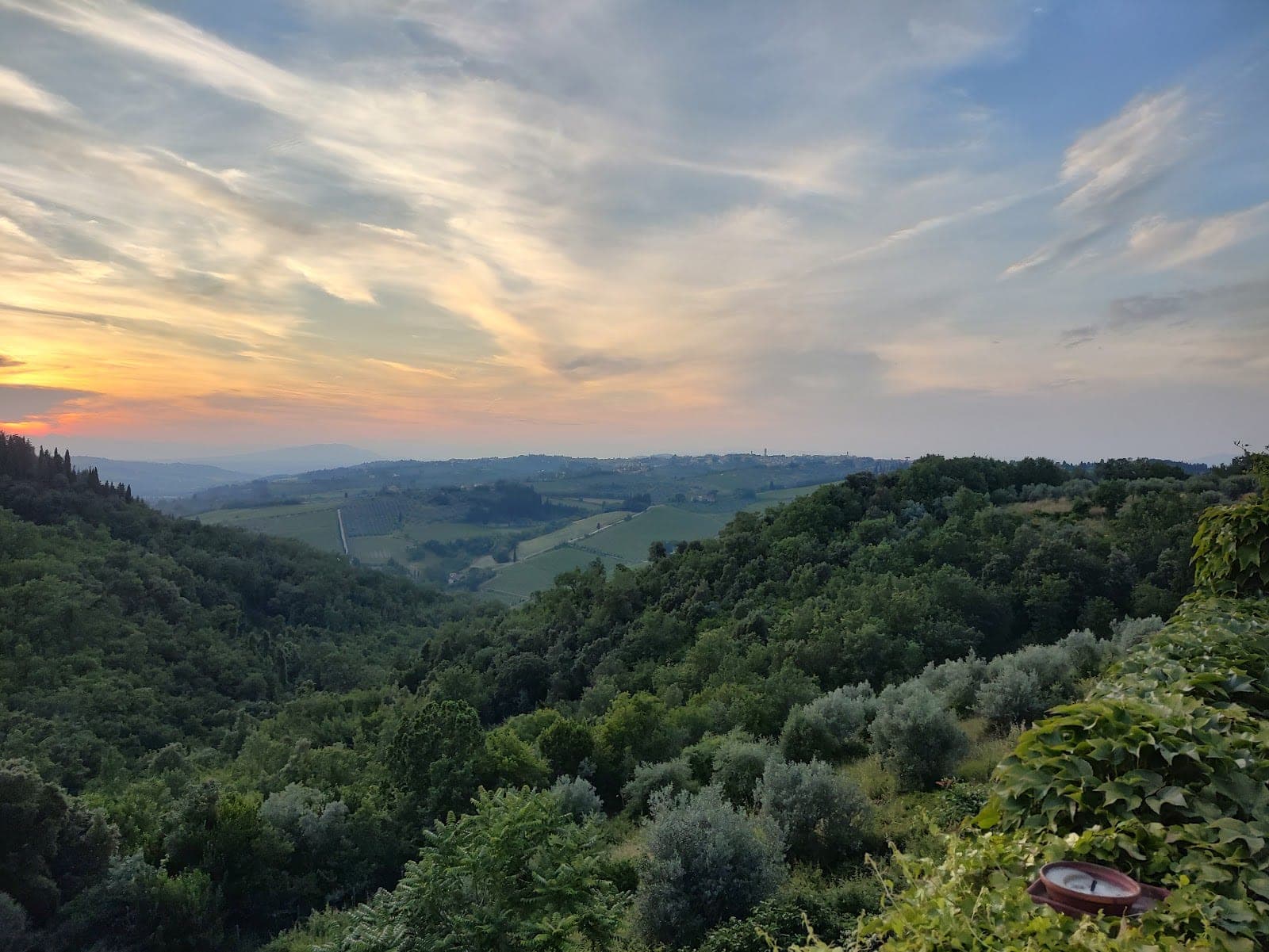 Tuscan landscape with rolling hills and vineyards at sunset