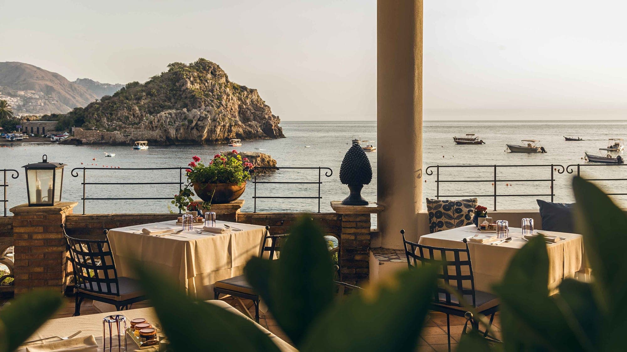 Terrace dining tables with sea view and boats