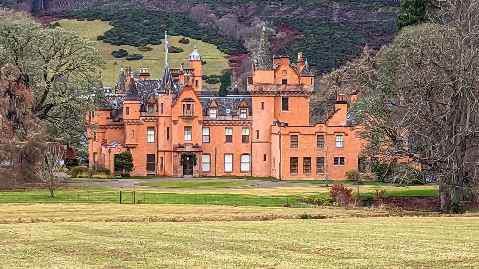 Aldourie Castle in its grounds on the shore of Loch Ness in the Highlands