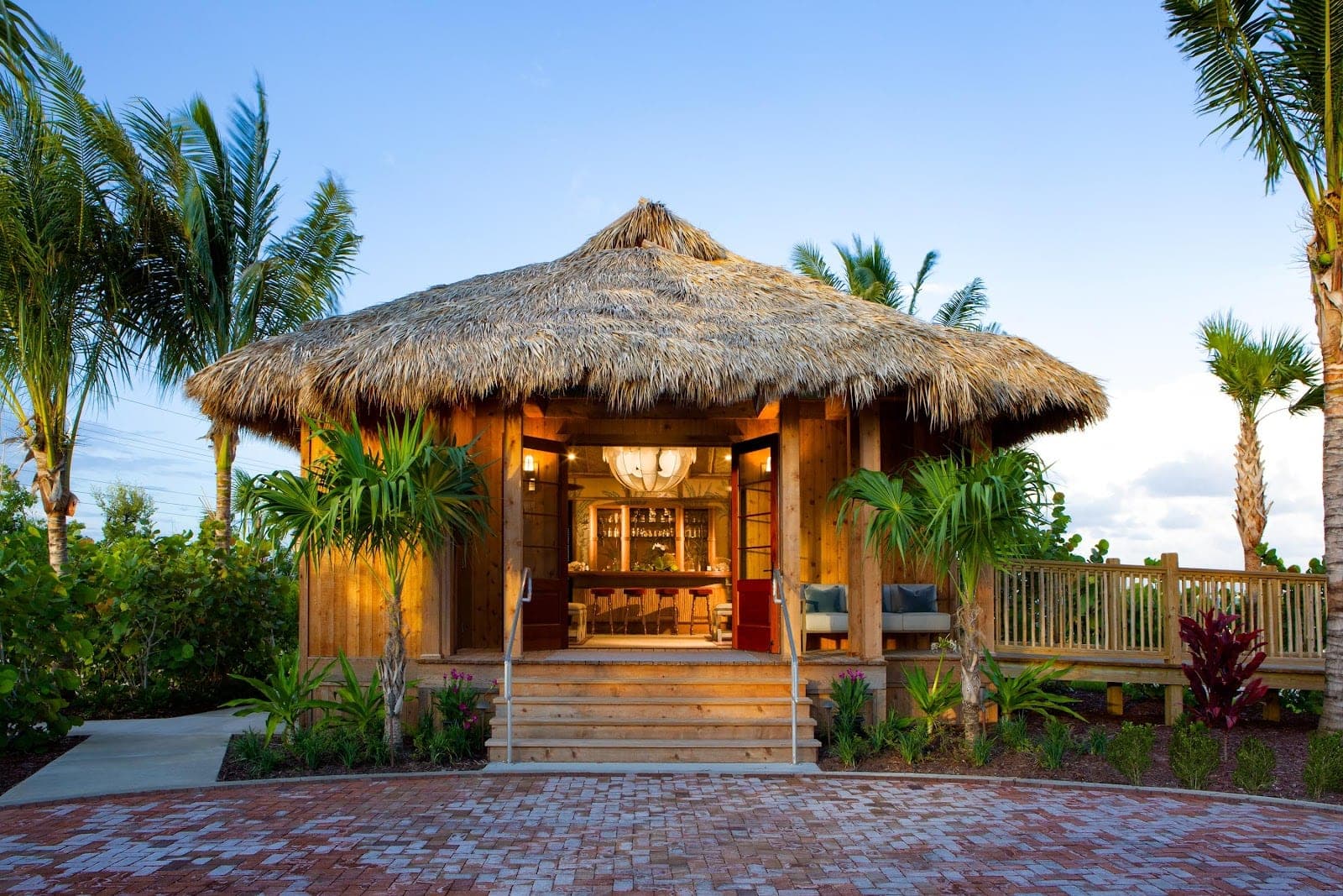 Thatched bungalows and palms on the beach at Little Palm Island in the Florida Keys