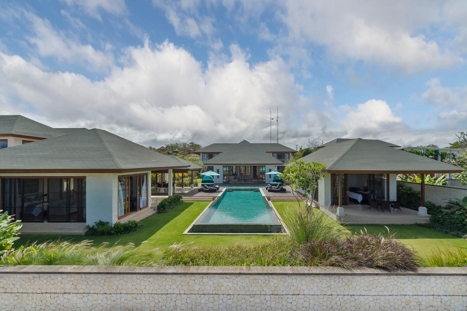 Pandawa Cliff Estate, four connected villas and pools on a limestone cliff above Pandawa Beach in Bali
